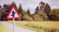 Country road with a priority crossroads sign in rural Scotland