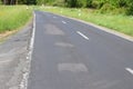 a country road with rather bad repairs of potholes that created further waves Royalty Free Stock Photo