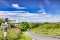 Lincolnshire Wolds, UK, with Country Road and Signpost Royalty Free Stock Photo