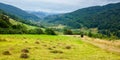 country road through rural field. suburban summer landscape in mountains Royalty Free Stock Photo