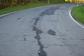 badly damaged road, some potholes not really repaired Royalty Free Stock Photo
