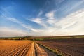 Country road in Spring arable fields