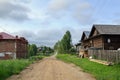 Unpaved street with old residetial houses. Village of Visim, Russia Royalty Free Stock Photo