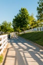 Country road surrounded the horse farms with evening fence shado Royalty Free Stock Photo
