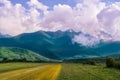 Country road towards mountains with clouds, Republic of Ingushetia, Fiagdon, city of the dead, road towards Karamadon Royalty Free Stock Photo