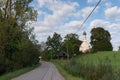 A country road, trees and a church in small Bavarian town Murnau