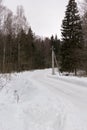 Country road turn in snowy winter forest Royalty Free Stock Photo