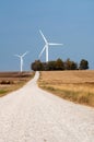 Country road and a wind farm Royalty Free Stock Photo