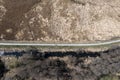 Country side dirt road among meadows and thickets in the countryside, aerial photo, drone photo Royalty Free Stock Photo