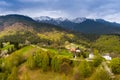 Country side landscape in Transylvania in the spring time with boomed trees , snow on the mountains in the background Romania