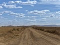 Country side view with empty road, blue sky and white cotton clouds Royalty Free Stock Photo