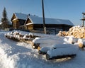 Country street in winter. Snow-covered old log houses. Visim, Sverdlovsk region, Russia