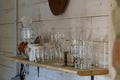 Country-style kitchen board wall with a shelf on which there are various glasses
