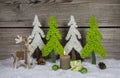 Country style wooden christmas decoration in apple green and white with candle and reindeer. Royalty Free Stock Photo