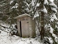 Country toilet in the winter outdoors. Outdoor toilet construction. Cabin - Toilet in the forest on the snow