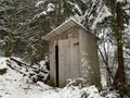 Country toilet in the winter outdoors. Outdoor toilet construction. Cabin - Toilet in the forest on the snow