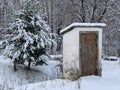 Country toilet in the winter outdoors. Outdoor toilet construction. Cabin - Toilet in the forest on the snow