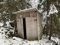 Country toilet in the winter outdoors. Outdoor toilet construction. Cabin - Toilet in the forest on the snow