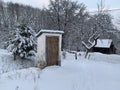 Country toilet in the winter outdoors. Outdoor toilet construction. Cabin - Toilet in the forest on the snow