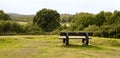Country view and empty bench.