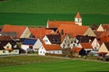 Small country village with church in green fields Royalty Free Stock Photo