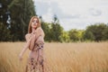 Freedom concept, elegant woman in long beige romantic dress at the field