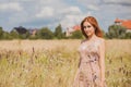 Freedom concept, elegant woman in long beige romantic dress at the field