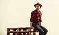 From the country. Vintage style man. Wild West retro cowboy. cowboy sit on woden pallet. Western. man checkered shirt on Royalty Free Stock Photo