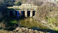 Old stone bridge over stream with dirty water, in Vitigudino, Spain. Royalty Free Stock Photo