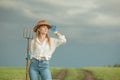 Country woman in field with pitchfork Royalty Free Stock Photo