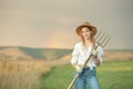 Country woman in field with pitchfork. Harvest festival Royalty Free Stock Photo