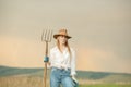 Country woman in field with pitchfork. Harvest festival Royalty Free Stock Photo