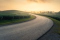 Countryside asphalt road curve surrounded by green tea plantation on hill in a beautiful morning sunrise, Chiang Rai province, Royalty Free Stock Photo