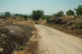 Countryside dirt road passing through rocky terrain Royalty Free Stock Photo