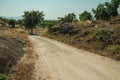 Countryside dirt road passing through rocky terrain Royalty Free Stock Photo