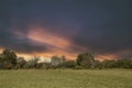 Countryside dutch meadow landscape with grass under scenic sunset sunrise sky. Panorama of dramatic landscape Royalty Free Stock Photo