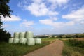 Countryside field with hay bale wrapped in plastic