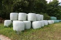 Countryside field with hay bale wrapped in plastic