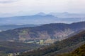 Countryside with forested hills and grassy plains.