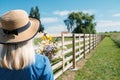 Countryside Getaways, Country vacations, Farm Stays. Young woman in straw hat enjoys summer vacation at the farm in Royalty Free Stock Photo