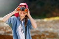 Countryside, girl and binocular to watch in nature or observe animals, sightseeing or explore outdoors. Adventure, child Royalty Free Stock Photo