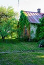 Countryside house garden backyard in summer with old buildings and decorations Royalty Free Stock Photo
