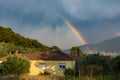 Countryside house over stormy sky with rainbow, traditional mountainous village, Thassos Island, Greece