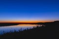 Countryside landscape, evening scenery dramatic sky during sunset native grasses in dark foreground Royalty Free Stock Photo