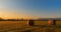 Countryside landscape.Hay bales on field at golden sunset. Royalty Free Stock Photo