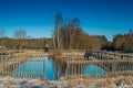 Countryside landscape of lake pond and wooden fence