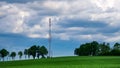 Countryside Landscape with straw hay bales on agricultural field, blue sky and power lines Royalty Free Stock Photo