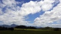 countryside, bucolic place, mountains, trees, clouds and blue sky Royalty Free Stock Photo