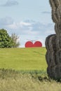 Countryside passion concept, big red heart in the middle of the fields Royalty Free Stock Photo