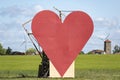 Countryside passion concept, big red heart in the middle of the fields Royalty Free Stock Photo